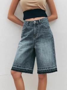 Women's vintage high waisted denim shorts in medium blue wash with straight leg cut