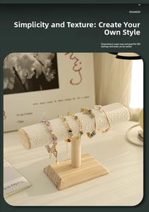 Detail of a T-bar jewelry display stand with a wooden base and white textured velvet