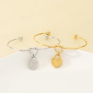 Dual-color gold and silver stainless steel knotted bangles with heart charms