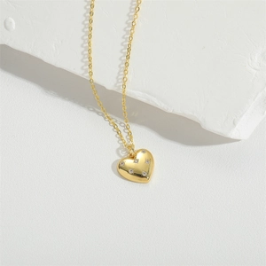 Minimalist gold heart pendant necklace with shimmering zircon stones on a fine chain