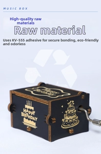 Detail of hand-cranked wooden music box featuring gold Happy Birthday cake patterns