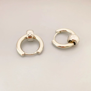 Silver quilted metal hoop earrings with embossed star beads in minimalist French style