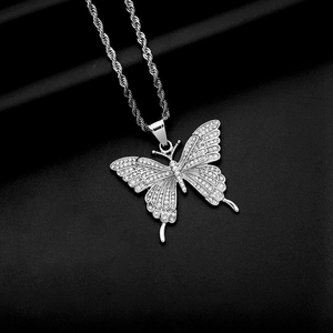 Detailed view of hip hop butterfly pendant with sparkling crystals on twisted rope chain