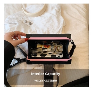 Detail view of the black and pink crossbody box bag showing spacious internal storage