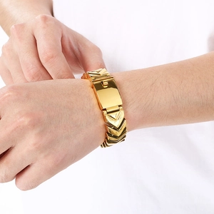 Close-up of men's chunky gold V-shaped chain bracelet with polished geometric facets