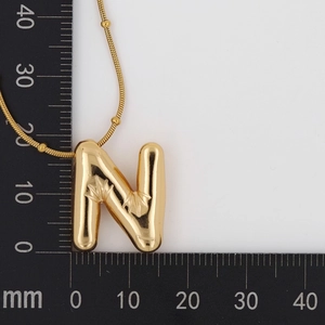 Detailed size measurement of a gold bubble letter N pendant on a ball chain necklace