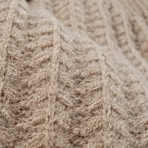Thick warm winter knitted beanie for women and men in light camel chunky yarn texture