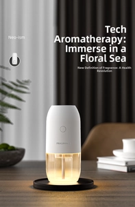 Detail of smart white fragrance diffuser with warm LED light and transparent reservoir
