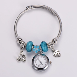 Detail of silver beaded watch bracelet featuring blue faceted beads and a swan pendant