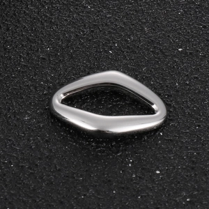 Macro shot of a silver geometric hollow twisted triangle pendant in polished steel