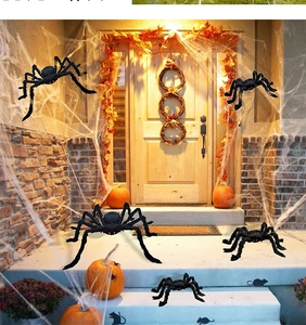 Detailed Halloween decor featuring giant black spiders and white webs on a porch