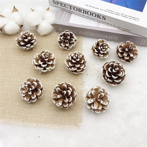 Close-up of natural pine cones with snow spray on a cozy Nordic home background