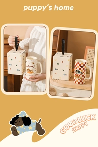 Detail view of two cute puppy ceramic mugs with matching gift box in yellow background