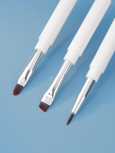 Three-piece professional dual-ended makeup brush set with white handles on blue background