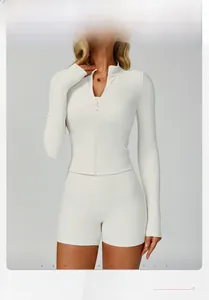 Detail of white ribbed knit fitness jacket showing breathable texture and slim fit design