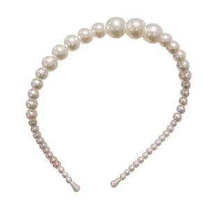 Elegant white pearl headband for women featuring a minimalist retro style on white background