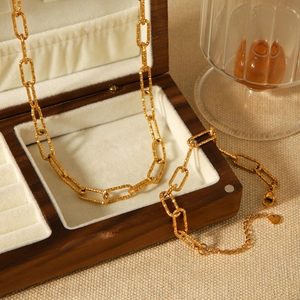 Hammered gold stainless steel rectangle link necklace displayed on a luxury wooden jewelry box