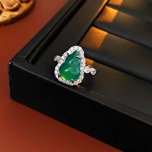 Macro view of vintage emerald gourd pendant necklace with zircon inlaid detailing