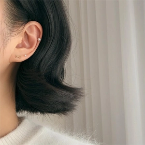 925 Sterling silver bow and pearl stud earrings set worn by a model in a soft setting