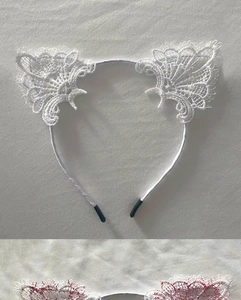 Detail of white lace cat ear headbands with mesh texture and slim metal frames