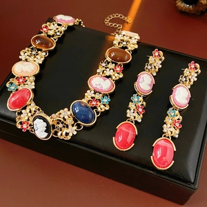Detailed view of vintage cameo jewelry set with rhinestones on a leather box