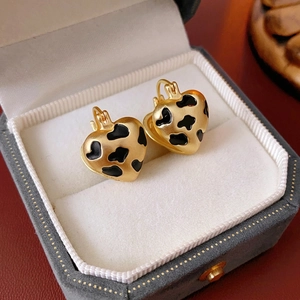 Vintage gold heart earrings with leopard pattern in luxury jewelry box