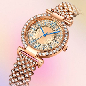 Detail of rose gold luxury quartz watch with rhinestone-encrusted band and Roman numerals