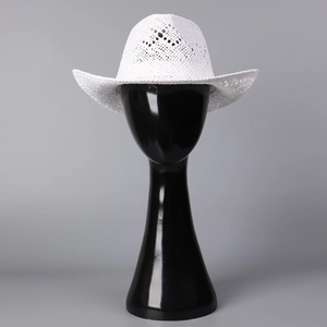 Detailed macro view of breathable hollow weave texture on white woven cowboy sun hat