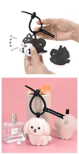 Close-up of cute leather husky and poodle charms with spiral lanyards and sound holes