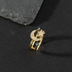 Detailed macro shot of a gold enamel evil eye ring with moon and star zircon details