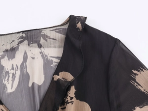 Detail of elegant necktie collar and brushstroke print on chiffon long dress