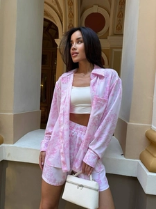 Detail of pink floral print loungewear set featuring long sleeve shirt and matching shorts