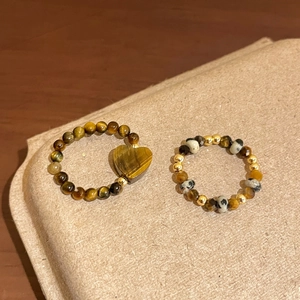 Tiger eye and dalmatian stone beaded rings with heart pendant in warm aesthetic style