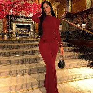 Detail of slim fit long sleeve burgundy dress with waist pleats and fishtail hem