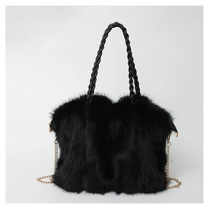 Detail of black faux fur tote bag with braided handle and golden metal chain strap