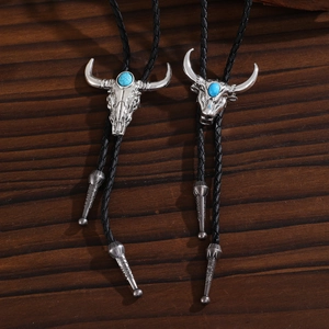 Detailed view of western bolo tie with silver bull head pendant and turquoise stone
