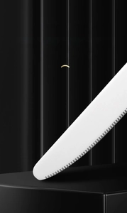 Macro shot of a sharp serrated edge on a premium stainless steel steak knife
