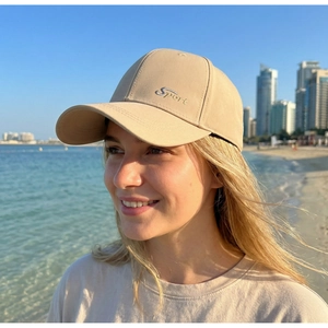 Detailed embroidery of Sport text on a beige cotton baseball cap for outdoor leisure