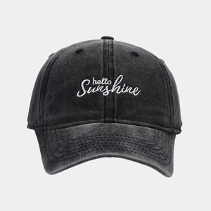 Close-up of white 'hello sunshine' embroidery on washed cotton baseball cap