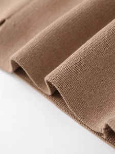Close-up of premium brown ribbed knit texture on a short sleeve collared jacket