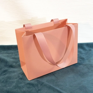 Elegant salmon pink jewelry gift bag with matching ribbed ribbon handles for rings