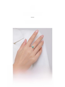 Close-up of S925 silver ring featuring emerald-cut green tourmaline and side diamonds