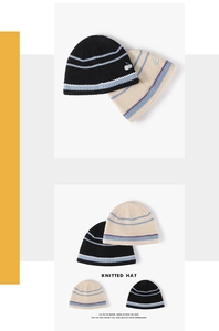 Detail view of winter knitted hat featuring thick striped texture and cherry embroidery
