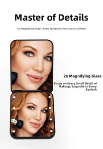 Detail view of foldable LED makeup mirror featuring 2x magnification and black finish