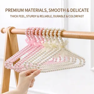 Elegant pearl pet hangers with silk bows for cat and dog clothes in white and pink