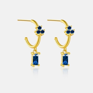 Close-up of S925 silver gold earrings with square and round navy blue zircon stones