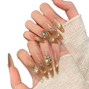 Ongles à presser oeil de chat ambre doré avec strass de luxe et forme stiletto