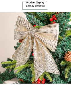 Sparkling champagne gold Christmas bow with rhinestones on a decorated festive tree branch