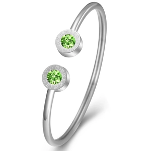 Detail of silver stainless steel bangle with green gemstone and Roman numerals