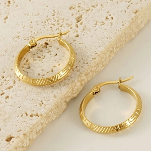 Golden titanium steel hoop earrings with Greek key engraving on beige stone base